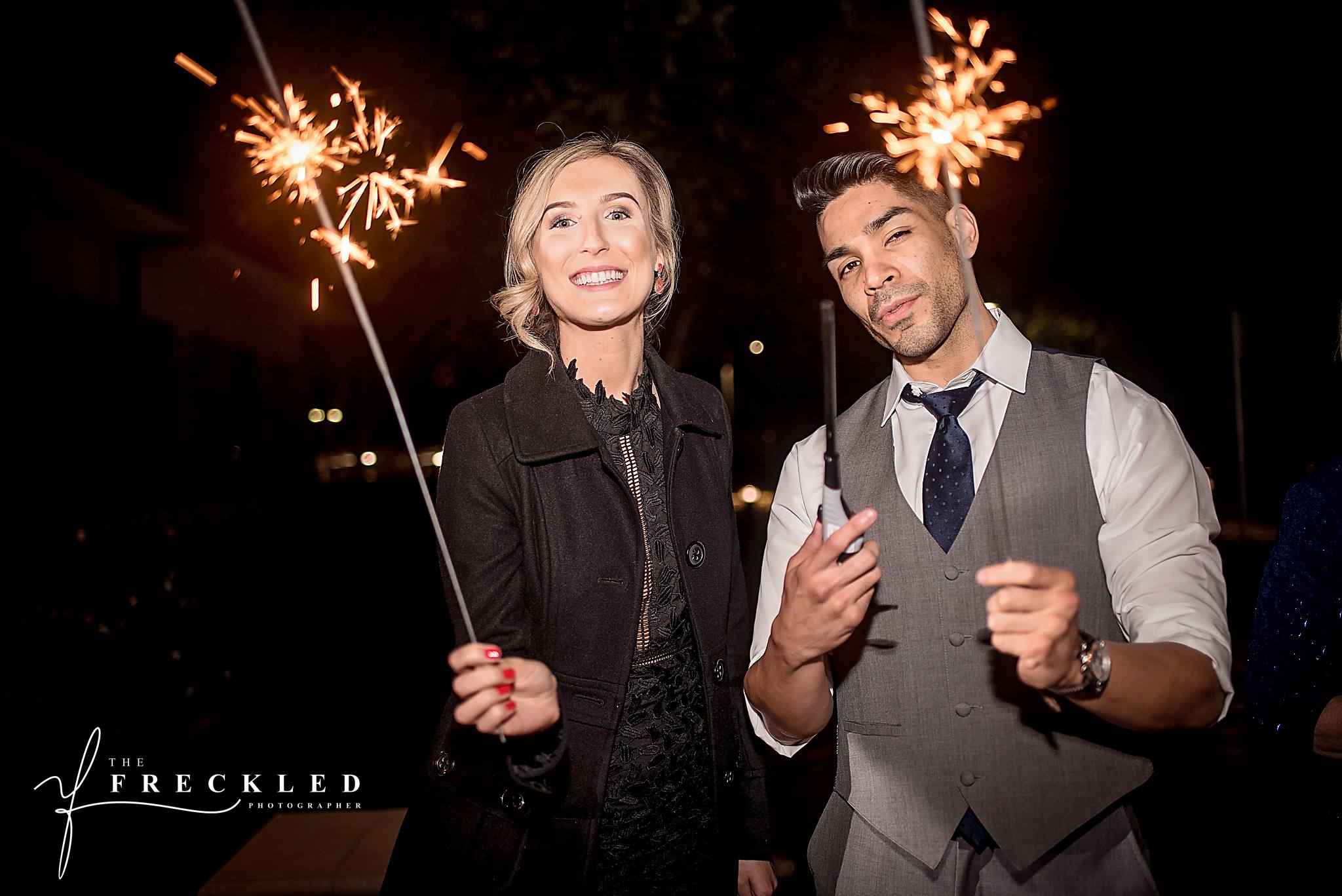 wedding guests hold sparklers in preparation of the sparkler exit